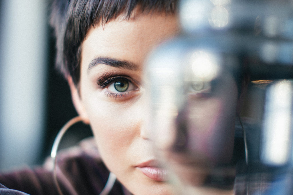 woman staring through glass