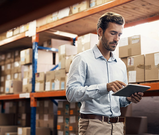 Pallet shipment warehouse worker on iPad