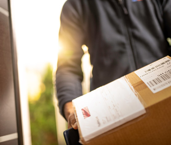 Photo of a carrier about to deliver a package that has been fulfilled via Scurri's delivery management platform