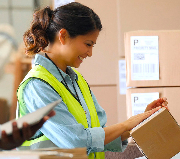 Woman in warehouse using eCommerce fulfillment software